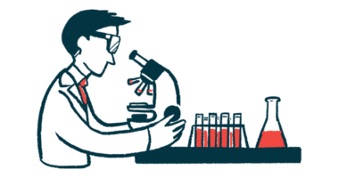 A researcher examining samples under a microscope in a lab.