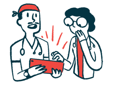 Two doctors look at and discuss information on an e-tablet.