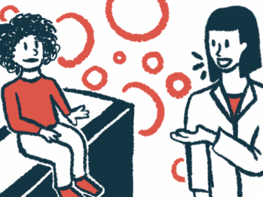 A doctor talks with a child sitting on an exam table.