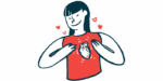 A woman wearing a shirt with a heart on it holds her chest.