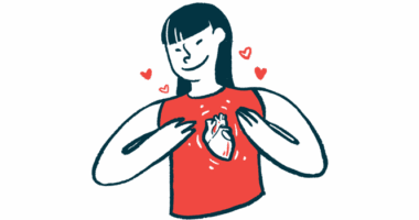 A woman wearing a shirt with a heart on it holds her chest.