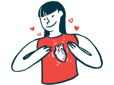 A woman wearing a shirt with a heart on it holds her chest.