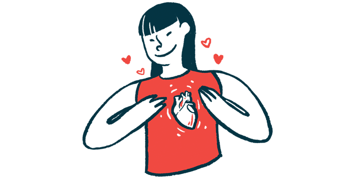 A woman wearing a shirt with a heart on it holds her chest.