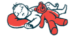 An illustration shows a baby sleeping with a teddy bear.